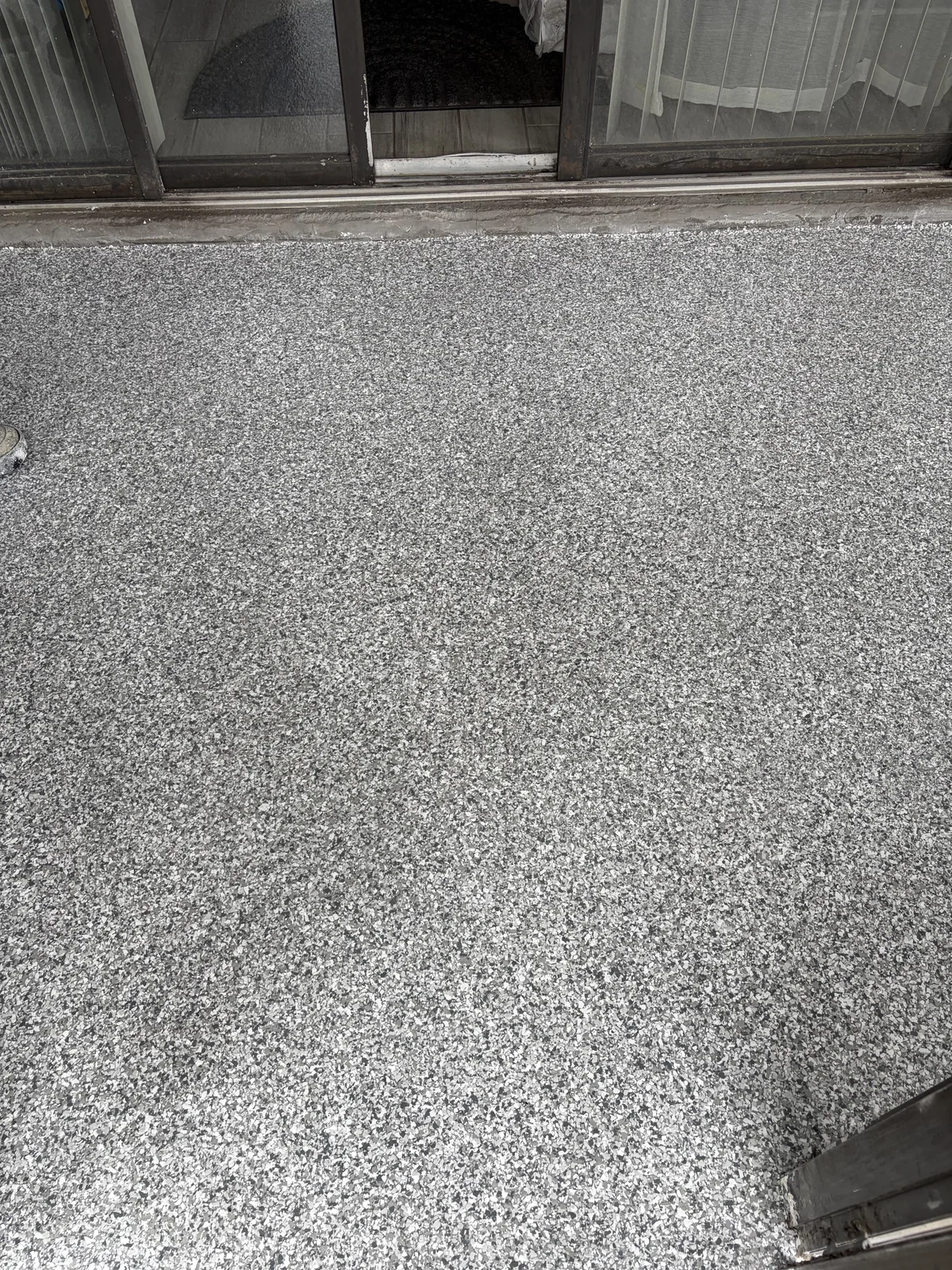Finished grey flake covered patio floor
