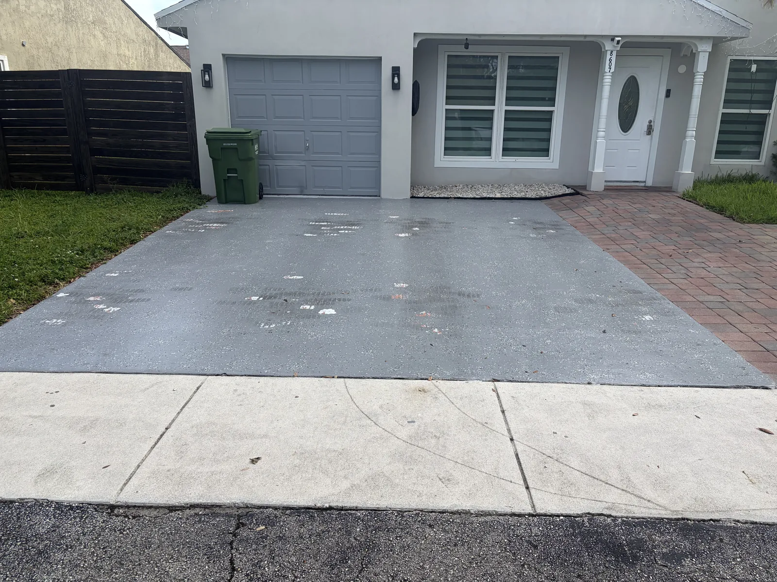 Faded patchy driveway before epoxy installation